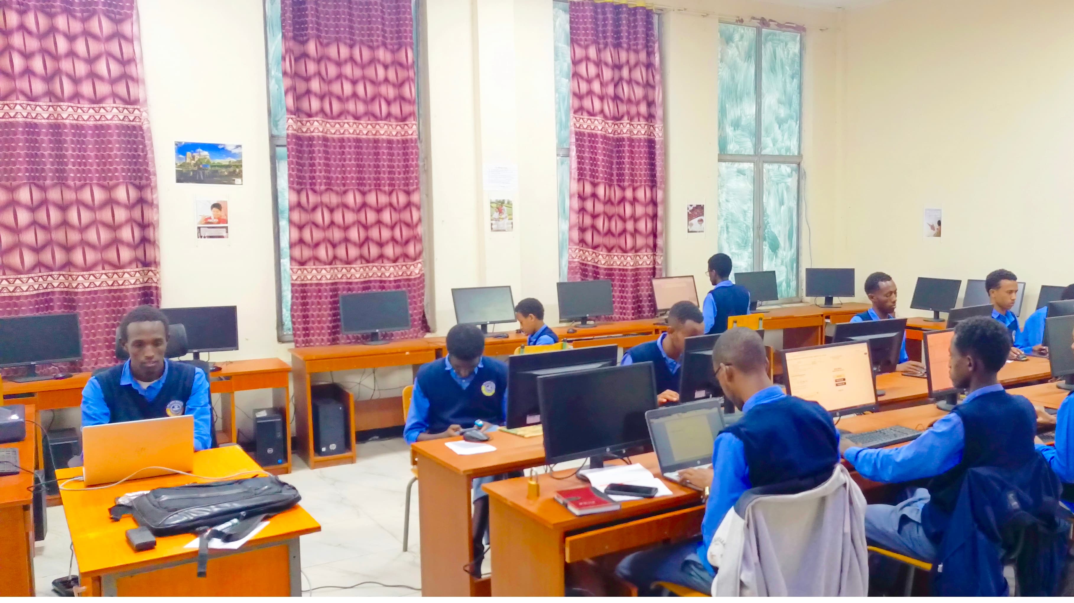 Students writing Python code during a DoCoder Program session at Dodola Ifa Boru Boarding School